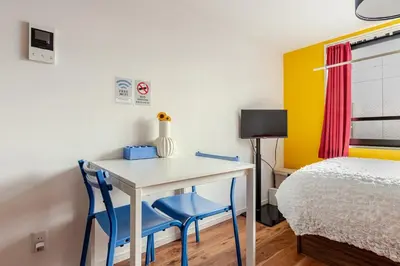 a small bedroom with a desk and a bed at jtr\u6d45\u8349\u6a4b302 in Tokyo