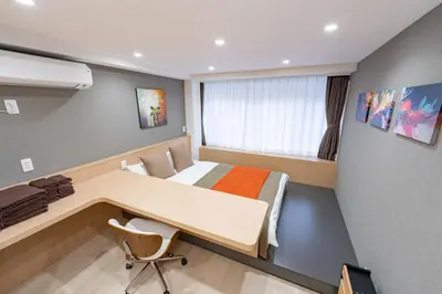 a small bedroom with a bed and a desk at Y's INN 駒込 110T in Tokyo