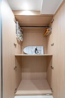 a walk in closet with wooden walls and shelves at Y's INN 駒込 110T in Tokyo