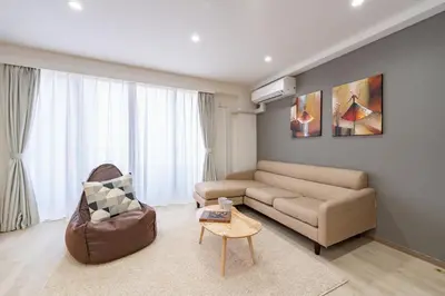 a living room with a couch and a table at Y's INN 駒込 110T in Tokyo