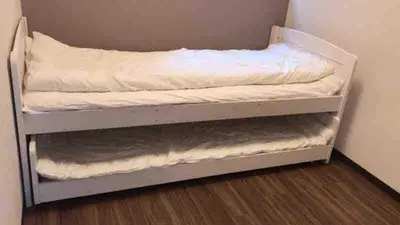 a bunk bed in a room with white sheets at \u4e09\u30ce\u8f2a101 in Tokyo