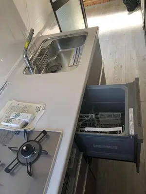 a kitchen counter with a sink and a dishwasher at \u4e09\u30ce\u8f2a101 in Tokyo