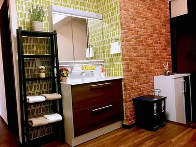 a bathroom with a sink and a brick wall at \u4e09\u30ce\u8f2a101 in Tokyo