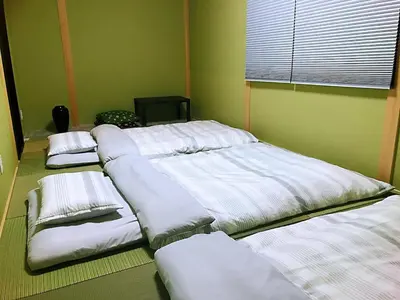 a group of beds in a room at \u4e09\u30ce\u8f2a401 in Tokyo