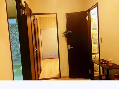 an open door to a room with a mirror at \u4e09\u30ce\u8f2a401 in Tokyo
