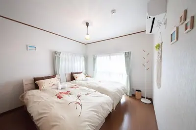 a bedroom with two beds and a window at \u697d\u5bbf \u58a8\u7530II 003t in Tokyo
