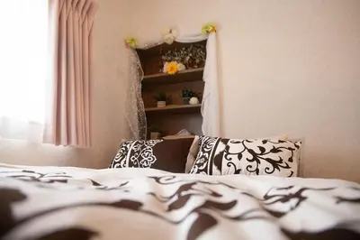 a bedroom with a bed with black and white pillows at \u697d\u5bbf \u58a8\u7530II 003t in Tokyo