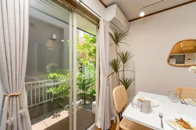 a dining room with a table and chairs and a large window at \u512a\u697d\u82d1 113t in Tokyo