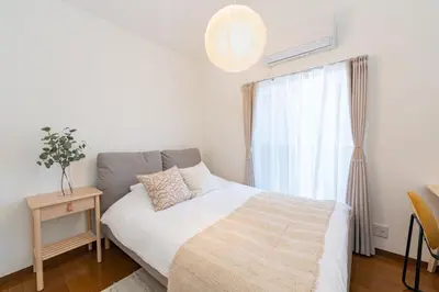 a small bedroom with a bed and a window at \u512a\u697d\u82d1 113t in Tokyo