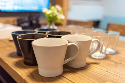 a group of cups sitting on a wooden table at \u697d\u9038 026t in Tokyo
