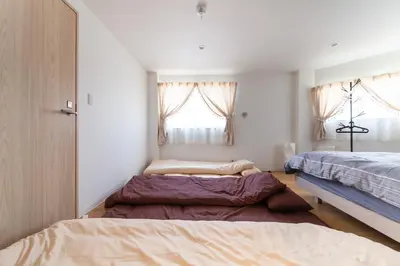 a bedroom with two beds and a window at \u697d\u5bbf \u4e2d\u4e95 004t in Tokyo