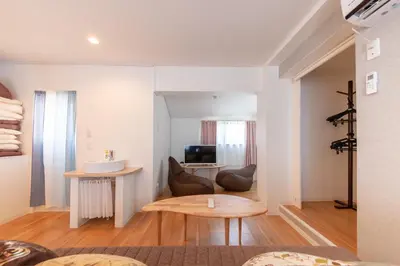 a living room with a table and a television at \u697d\u5bbf \u4e2d\u4e95 004t in Tokyo