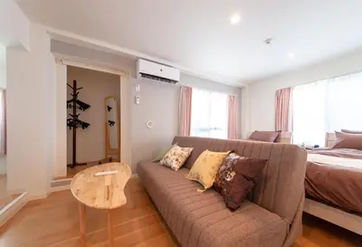 a living room with a couch and a bed at \u697d\u5bbf \u4e2d\u4e95 004t in Tokyo