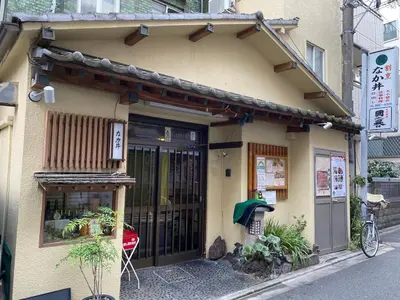 a building with a door and a bike parked outside at \u697d\u5bbf \u4e2d\u4e95 004t in Tokyo