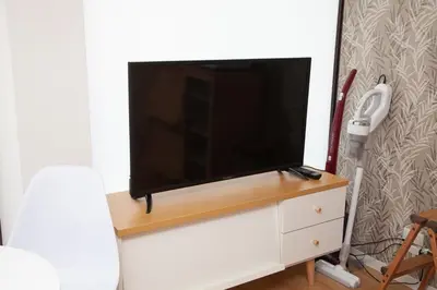 a flat screen tv sitting on top of a dresser at \u697d\u5bbf \u4e2d\u4e95 004t in Tokyo