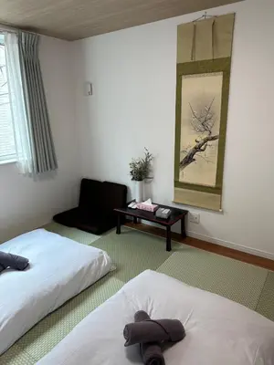 a hotel room with two beds and a table at \u53f0\u4e1c\u533a\u677e\u8c37 in Tokyo
