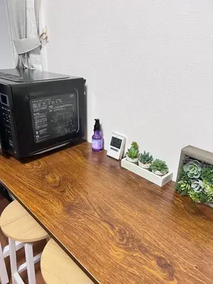 a microwave sitting on top of a wooden table at \u53f0\u4e1c\u533a\u677e\u8c37 in Tokyo