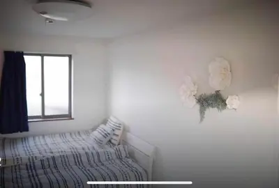 a bedroom with a bed and flowers on the wall at Y's INN Nirinso 001T in Tokyo