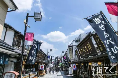 a street in an asian city with flags and buildings at Y's INN Nirinso 001T in Tokyo