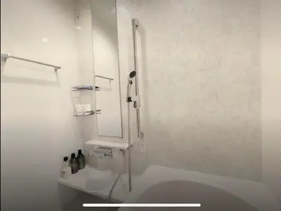 a white bathroom with a sink and a mirror at Y's INN Nirinso 001T in Tokyo