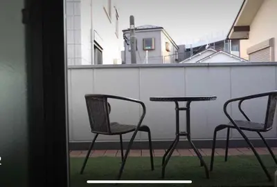 two chairs and a table on a balcony at Y's INN Nirinso 001T in Tokyo