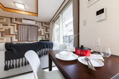 a living room with a table and a couch at Y's INN 有客 015T in Tokyo