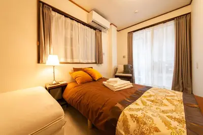 a bedroom with a large bed and a window at Y's INN 有客 015T in Tokyo
