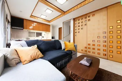 a living room with a blue couch and a table at Y's INN 有客 015T in Tokyo