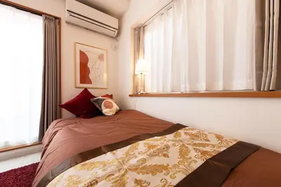 a bedroom with two beds and a window at Y's INN 有客 015T in Tokyo