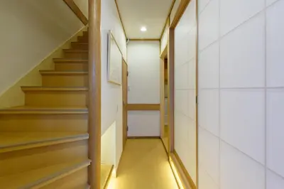 a hallway with stairs in a house at \u697d\u9038\u30b0\u30eb\u30fc\u30d7 \u65b0\u5bbf\u5fa1\u82d1 112t in Tokyo