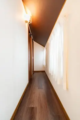 a hallway with a ceiling fan and a window at Y's INN Tsutusji 014T in Tokyo
