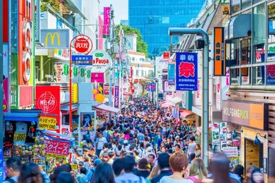 a crowd of people walking down a busy city street at Y's INN Tsutusji 014T in Tokyo