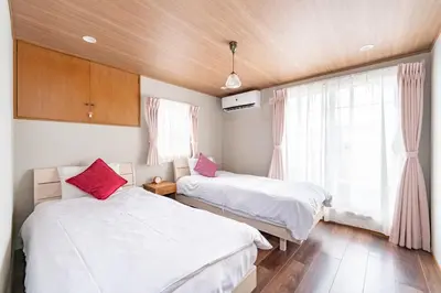 a bedroom with two beds and a window at Y's INN Tsutusji 014T in Tokyo