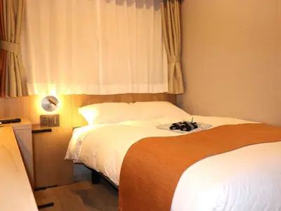 a hotel room with two beds and a window at Tokyo Inn - Vacation STAY 74540v in Tokyo