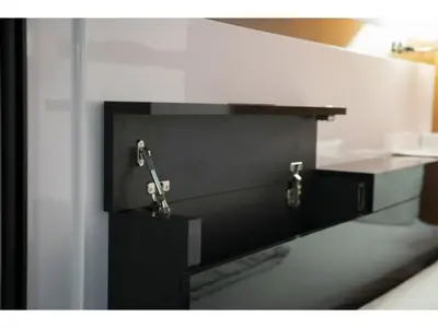a bathroom with a black and white counter with two hooks at First Cabin Ichigaya 