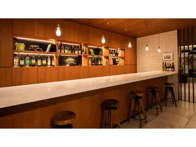 a bar in a restaurant with stools at First Cabin Ichigaya 