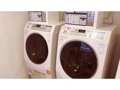 two washing machines sitting next to each other at First Cabin Ichigaya 