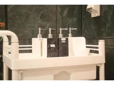 a white bathroom sink with four toothbrushes on it at MIYAVI hotel - Vacation STAY 75556v in Tokyo