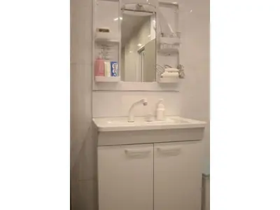 a white bathroom with a sink and a mirror at MIYAVI hotel - Vacation STAY 75556v in Tokyo