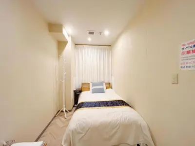 a small bedroom with a bed in a room at MIYAVI hotel - Vacation STAY 75579v in Tokyo
