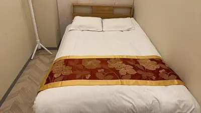 a bed with a blanket on it in a room at MIYAVI hotel - Vacation STAY 75566v in Tokyo