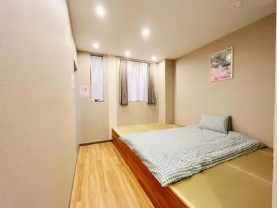 a small bedroom with a bed in the corner at MIYAVI hotel - Vacation STAY 75546v in Tokyo