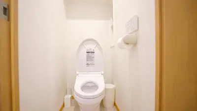 a small bathroom with a toilet with the lid up at Yuina Hotel Shinjuku in Tokyo