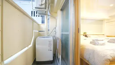 a small room with a bed and a window at Yuina Hotel Shinjuku in Tokyo
