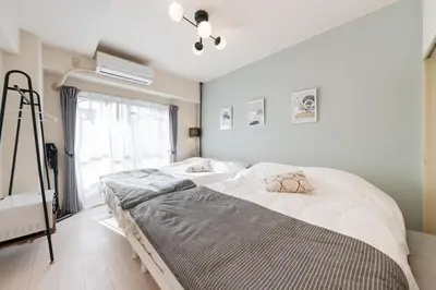a bedroom with two beds and a window at Frt\u6c60\u888b2\u4e01\u76ee906 in Tokyo
