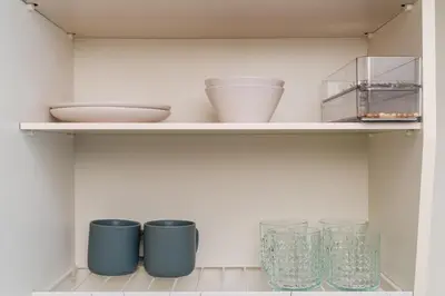 a shelf with bowls and glasses on it at Frt\u6c60\u888b2\u4e01\u76ee906 in Tokyo