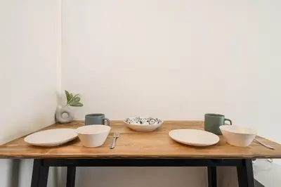 a wooden table with plates and cups on it at Frt\u6c60\u888b2\u4e01\u76ee906 in Tokyo