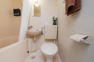 a white bathroom with a toilet and a sink at Frt\u6c60\u888b2\u4e01\u76ee906 in Tokyo