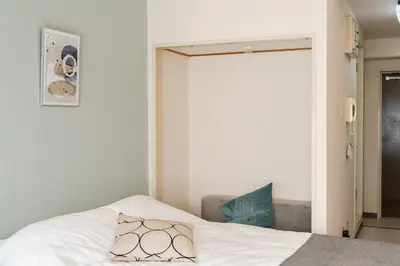 a bedroom with a bed and a sliding door at Frt\u6c60\u888b2\u4e01\u76ee906 in Tokyo