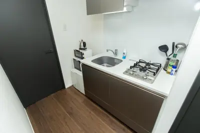 a small kitchen with a sink and a stove at #17 -\u30b7\u30fc\u30d5\u30a9\u30eb\u30e0\u4eac\u6025\u84b2\u7530- Entire Unit in Tokyo